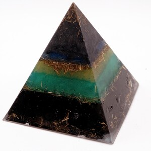 May include: A layered pyramid sculpture with a black base, transitioning to green, yellow, and blue bands. The pyramid is embedded with gold-colored strands, creating a unique, geometric art piece.