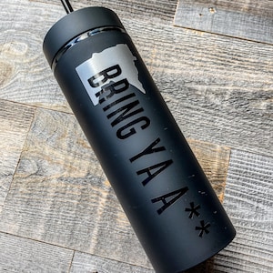 May include: Black stainless steel tumbler with a silver outline and the text "Bring Ya A**" in black lettering.