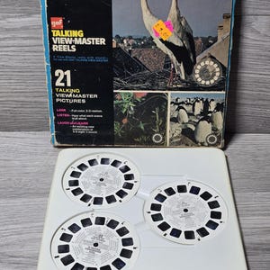 May include: A vintage "Birds of the World" View-Master reel set. The box shows storks and penguins. The set includes three reels and a white tray. The box has the text "TALKING VIEW-MASTER REELS".