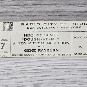 May include: A black and white ticket for the NBC show "Dough-Re-Mi" with Gene Rayburn. The show is a new musical quiz show. The ticket is for Tuesday, April 7, 1959 at 10:00 AM at Radio City Music Hall in New York City.
