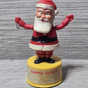 May include: A set of three ceramic mugs with a speckled, matte finish. The mugs are in shades of cream, light gray, and dark gray. Each mug has a simple, minimalist design, perfect for coffee or tea.