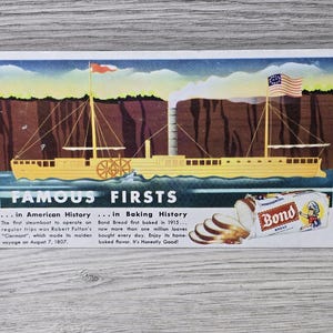 May include: Vintage postcard showing a yellow steamboat with flags and the text "FAMOUS FIRSTS." The postcard also includes a loaf of Bond Bread and text about the first steamboat and Bond Bread.