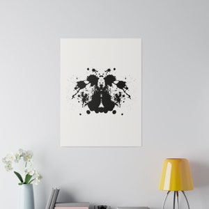 May include: A black and white inkblot image, similar to those used in the Rorschach test. The inkblot is symmetrical and has a variety of shapes and forms.
