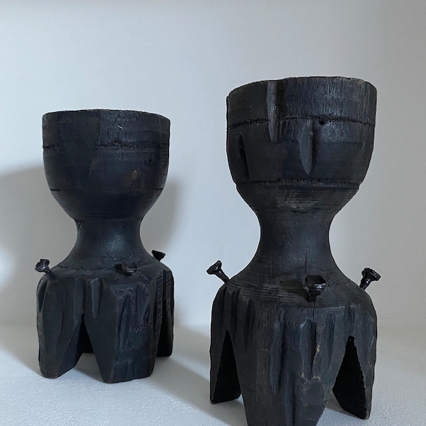 A Pair of Antique 1900s Ebonised Wood Hand Carved Primitive Candle Holders Blackened Brass Nail Detail