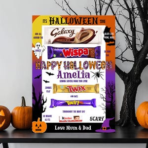 May include: A Halloween poster featuring chocolate bars like Galaxy, Wispa, Twix, and Twirl, with the message "Happy Halloween Amelia." The design includes pumpkins, bats, and the text "Love Mum & Dad."
