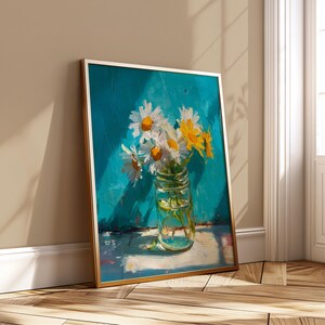 May include: A framed painting depicting a bunch of daisies in a clear glass jar. The daisies have white petals and yellow centres, with some yellow daisies mixed in. The background is a textured teal colour, and the frame is gold.