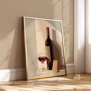 May include: A framed art print featuring a still life of a wine bottle, a glass of red wine, and a wedge of cheese. The wine bottle is dark red with a tan label and a brown top. The glass is filled with red wine. The cheese is light brown.