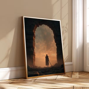 May include: Framed art print featuring a silhouetted figure standing before a stone archway. The artwork depicts a dramatic sunset with orange and yellow hues. The figure holds a sword, suggesting a fantasy or historical theme.