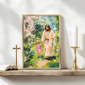 May include: A painting of Jesus walking with a young girl through a lush green forest. The painting is framed in a light wood frame.