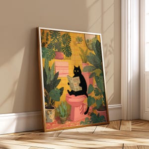 May include: A framed art print depicts a black cat reading a newspaper while seated on a pink toilet. The bathroom scene is filled with lush green plants and yellow tiled walls, creating a whimsical and cozy atmosphere.