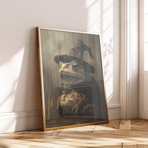 May include: Framed art print depicting a toad wearing a witch's hat. The toad is set against a wooden backdrop, enclosed within a gold frame. The artwork has a whimsical and fantasy theme, suitable for home decor.