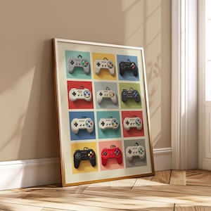 Può includere: Una stampa incorniciata con una griglia di controller di videogiochi retrò colorati. Ogni controller è di un colore diverso, tra cui grigio, bianco, nero e rosso, con pulsanti colorati. I quadrati di sfondo sono di vari colori.