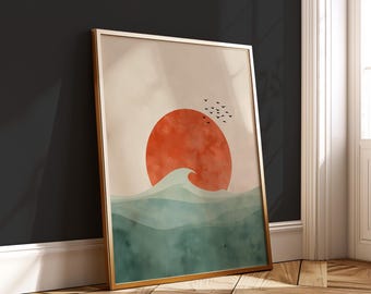 Puede incluir: Impresión artística enmarcada que representa una escena minimalista de la puesta de sol. Un gran sol naranja se pone sobre olas turquesas, con una bandada de pájaros en el cielo. La obra de arte está en un marco dorado.