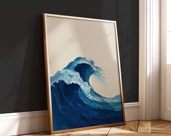 May include: A framed art print featuring a stylized depiction of a large ocean wave. The wave is rendered in shades of blue, with a crest of white foam. The artwork is set against a neutral background and framed in a gold-colored frame.