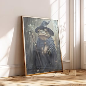May include: A framed art print depicting a frog in wizard attire. The frog is wearing a pointed hat and cape, holding a staff. The artwork has a vintage, fantasy theme and is presented in a gold frame.