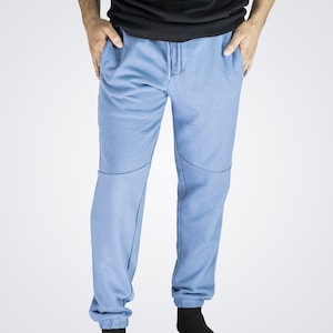 May include: A pair of light blue sweatpants with a drawstring waist and cuffed legs.