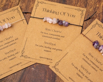 May include: Three gemstone bracelets on cards with the text "Thinking Of You". Each bracelet features Rose Quartz and Amethyst beads. The cards have decorative borders and text about the stones' properties.