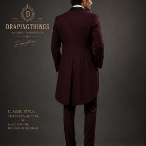 May include: A deep burgundy tailcoat suit featuring a black lapel, two back buttons, and a long tail design. The text D DRAPINGTHINGS TAILORED TO PERFECTION, Drapingthings, CLASSIC STYLE. TIMELESS APPEAL. BUILT FOR THE MODERN GENTLEMAN is visible.