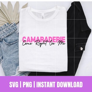 May include: White t-shirt with pink text that reads "CAMARADERIE Come Right On Me".