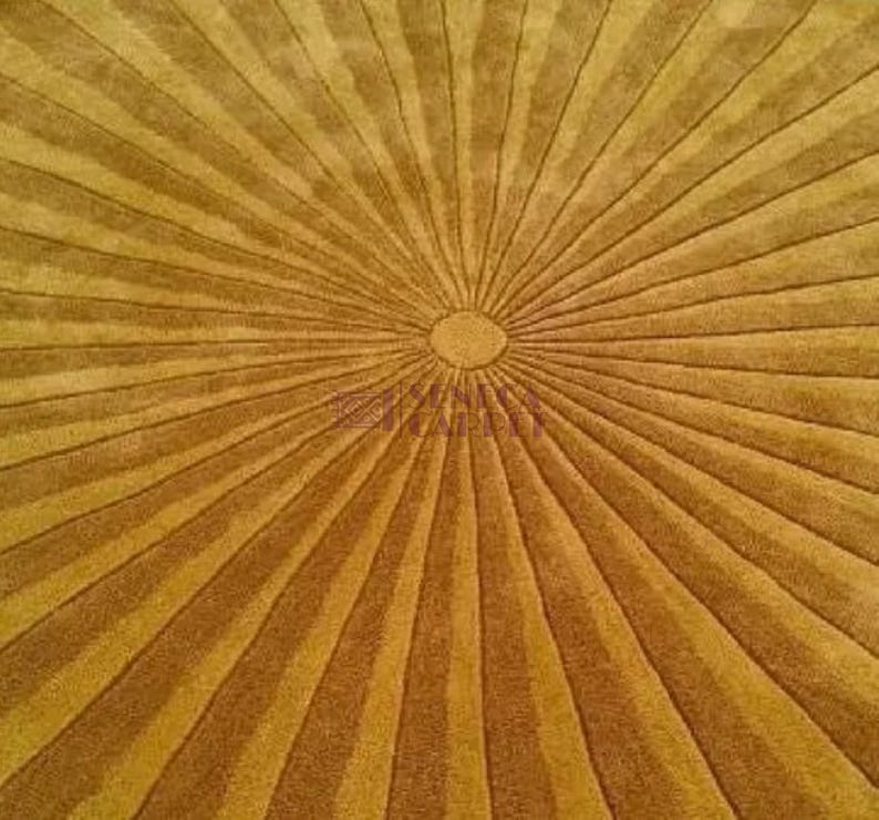 A close-up, overhead view of a mustard yellow round rug with a sunburst pattern radiating from the center.
