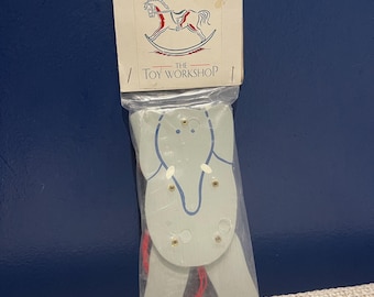 Wooden string pull jumping jack elephant.