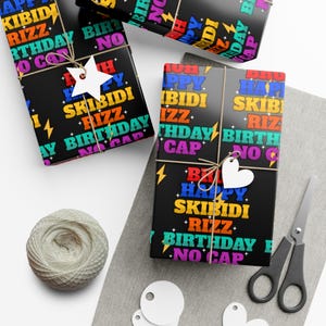 May include: Black wrapping paper with a repeating pattern of colourful text that says "Happy Skibidi Rizz Birthday No Cap".