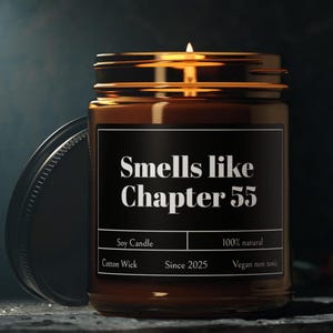 May include: A brown glass candle jar with a black label that reads "Smells like Chapter 55". The label also includes the details "Soy Candle", "Cotton Wick", "Since 2025", "100% natural", and "Vegan non toxic".