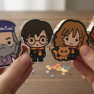 May include: Four cartoon character stickers from the Harry Potter series. The stickers feature Dumbledore, Harry Potter, Hermione Granger with a cat, and Ron Weasley with a small owl. Each character is wearing their signature outfit and holding a wand.