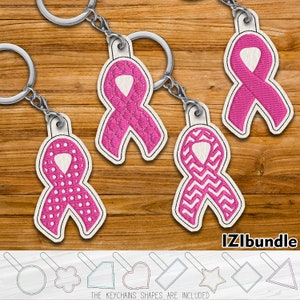 May include: Five pink ribbon keychains with different patterns, including quilted, polka dot, and chevron. The keychains are on a wooden background. The text "IZLbundle" is at the bottom of the image. The keychains are included in different shapes, including a circle, flower, rectangle, heart, star, diamond, and triangle.
