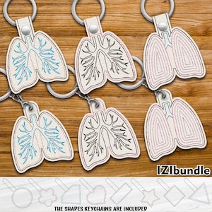 May include: Four different embroidered keychains featuring a stylised anatomical illustration of the lungs. The keychains are made of white fabric with a light brown background. The keychains are attached to silver key rings. The image also includes a row of different shapes, including a circle, a flower, a triangle, a heart, a rectangle, a star, a diamond, and a triangle.