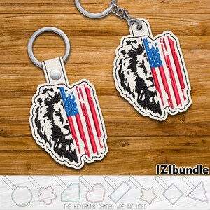 May include: Two keychains featuring a lion's head design and an American flag. The lion's head is black, and the flag has red and white stripes with a blue field of stars. The keychains are attached to silver keyrings. The text "IZIbundle" is visible.