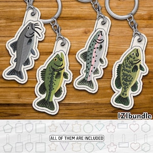 May include: Embroidered fish keychains in various colors, including gray, green, and pink, with silver keyrings. The keychains are on a wooden surface. The text "IZIbundle" and "ALL OF THEM ARE INCLUDED" are visible.