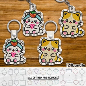 May include: Embroidered cat keychains with a strawberry hat and heart design, in white, yellow, and pink. The keychains are attached to silver keyrings. The image also includes a variety of keychain shape templates. The text "IZIbundle" and "ALL OF THEM ARE INCLUDED" are visible.