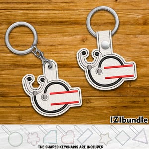 May include: Two white leather keychains with a stethoscope and red stripes. The keychains are attached to silver key rings. The text "IZLibundle" is visible in the bottom right corner of the image. The text "THE SHAPES KEYCHAINS ARE INCLUDED" is visible in the bottom center of the image.