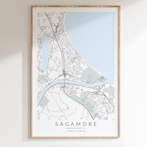 May include: A black and white map print of Sagamore, Massachusetts. The map shows the roads, waterways, and land features of the town. The map is framed in a light wood frame.