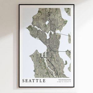 May include: A black and white map print of Seattle, Washington. The map shows the city's streets and waterways. The text "SEATTLE" and "WASHINGTON 47.6062° N, 122.3321° W" is printed below the map.
