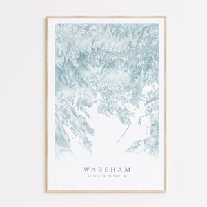 May include: A framed print of a blue and white abstract map of Wareham, Massachusetts. The coordinates 41.7615° N, 70.7197° W are printed below the name of the town.