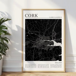 May include: Black and white map print of Cork, Ireland with the city name and coordinates "51.8985° N, 8.4760° W" at the top. The map is framed in a gold frame and has a white background.