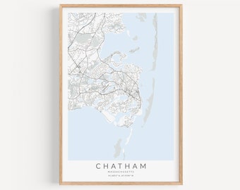 May include: A framed map of Chatham, Massachusetts, with a light blue background and black lines showing roads and waterways. The text "CHATHAM" is printed in black at the bottom of the map, along with the coordinates "41.6821° N, 69.9189° W".