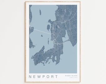 May include: A blue and white map print of Newport, Rhode Island. The map shows the city's streets and waterways. The text "NEWPORT" and "RHODE ISLAND" is printed at the bottom of the map.