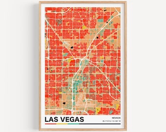 May include: A colorful map of Las Vegas, Nevada, with a red, orange, and yellow color scheme. The map is framed in a light wood frame. The text "LAS VEGAS" is printed in bold, black letters at the bottom of the map, with a colorful stripe underneath. The text "NEVADA" is printed in black letters above the coordinates "36.1719° N, 115.1381° W".