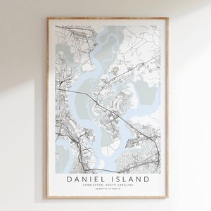 May include: A black and white map of Daniel Island, Charleston, South Carolina. The map shows the island's streets, waterways, and coastline. The text "DANIEL ISLAND" and "CHARLESTON, SOUTH CAROLINA" is printed below the map.