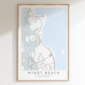 May include: A framed minimalist map print of Minot Beach, Scituate, Massachusetts. The map features black lines depicting roads and waterways against a light blue and gray background. The text "MINOT BEACH" is centered at the bottom, with coordinates below.