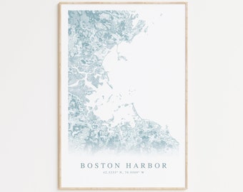 May include: A framed print of a blue and white map of Boston Harbor. The map is a stylized illustration of the harbor and surrounding area. The text "BOSTON HARBOR" and the coordinates "42.3255° N, 70.9509° W" are printed below the map.