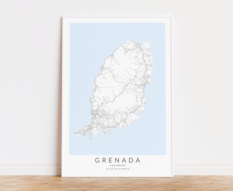 May include: A minimalist black and white map print of Grenada, a Caribbean island, with a light blue background. The map shows the island's roads and rivers. The text "GRENADA" and "CARIBBEAN" are printed below the map, along with the coordinates "12.1155&deg; N, 61.4790&deg; W".