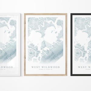 May include: Three framed prints of a map of West Wildwood, New Jersey. The maps are in shades of blue and white, with the text "WEST WILDWOOD" and coordinates at the bottom. Frames are white, natural wood, and black.