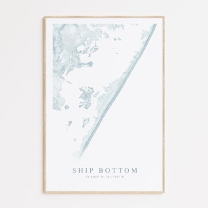 May include: A framed print of a light blue map of Ship Bottom, New Jersey. The map shows the coastline and surrounding land. The text "SHIP BOTTOM" and the coordinates "39.4342° N, 74.1742° W" are printed below the map.