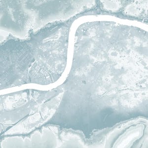 May include: An aerial view of a city with a winding river running through it. The river is white and the city is a light blue color.