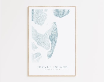 May include: A minimalist print of Jekyll Island, Georgia, with a blue and white color scheme. The print features a detailed outline of the island with the text "Jekyll Island" and coordinates "31.0739° N, 81.4114° W".