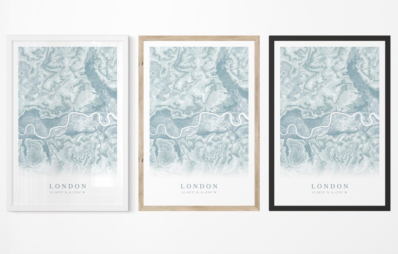May include: Three framed prints of a map of London, each with a different colored frame: white, natural wood, and black. The map is a blue and white abstract design with the word "LONDON" and coordinates printed at the bottom.